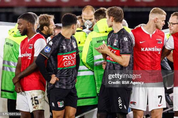 Players of NEC, players of AZ protecting the privacy of Bas Dost of NEC who is down on the ground with a medical emergency during the Dutch...