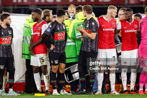 Players of NEC, players of AZ protecting the privacy of Bas Dost of NEC who is down on the ground with a medical emergency during the Dutch...