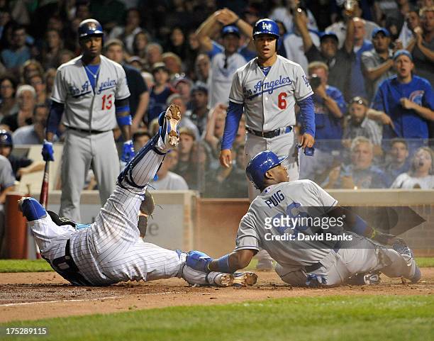Yasiel Puig of the Los Angeles Dodgers is tagged out at home plate by Dioner Navarro of the Chicago Cubs during the sixth inning on August 1, 2013 at...