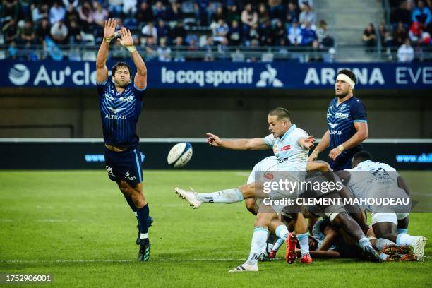 Racing 92's French fly-half Antoine Gibert kicks the ball from a Racing ruck during the French Top14 rugby union match between Montpellier Herault...