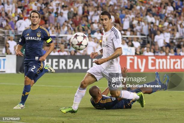 Angel Di Maria of Real Madrid scores a first half goal past Todd Dunivant and Leonardo of the Los Angeles Galaxy during the International Champions...