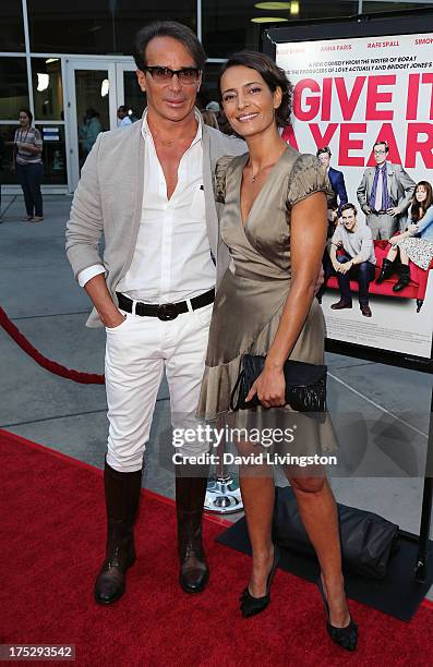 French couturier Lloyd Klein and Bahia Haifi attend a screening of Magnolia Pictures' "I Give It a Year" at ArcLight Hollywood on August 1, 2013 in...