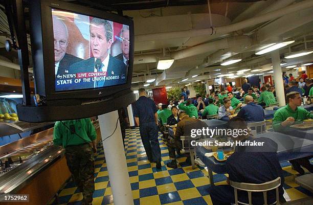 Crewmen aboard the USS Nimitz listen to U.S. President George W. Bush's State of the Union Addressh January 28, 2003 aboard the USS Nimitz, off the...