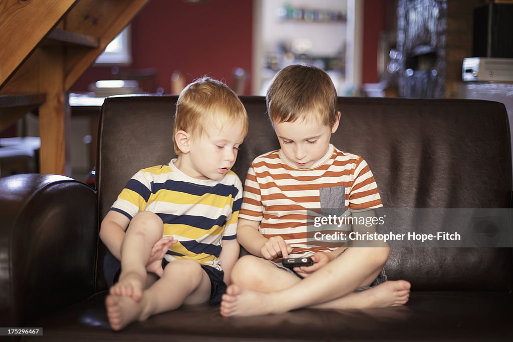 Brothers playing on a smartphone