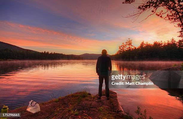 man standing on shore of adirondack lake - lake george new york stock pictures, royalty-free photos & images