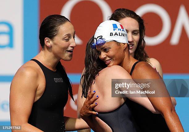 Charlotte Bonnet hugs Coralie Balmy after France take bronze in the Women's 4x200m Freestyle Relay Final at the Palau Sant Jordi on day thirteen of...