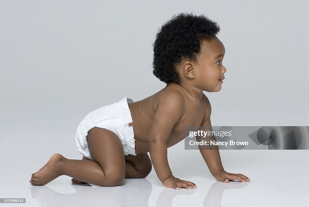 African American baby girl crawling