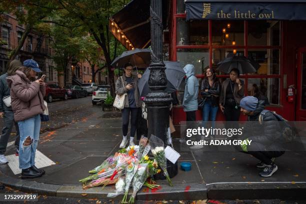 Floral tributes are left for actor Matthew Perry outside the apartment building which was used as the exterior shot in the TV show "Friends" in New...