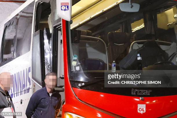 Photograph taken at Stade Velodrome in Marseille, southern France on October 29 shows Lyon's team bus, with one window completely broken and another...