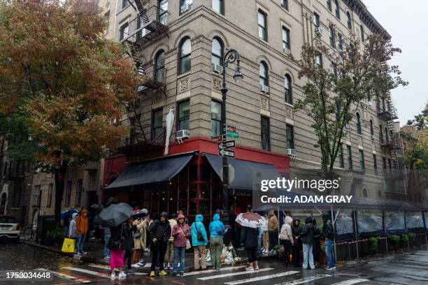 People stand in line to pay tribute to actor Matthew Perry outside the apartment building which was used as the exterior shot in the TV show...