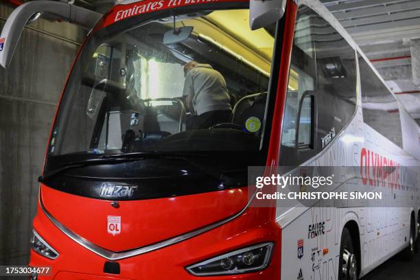 Photograph taken at Stade Velodrome in Marseille, southern France on October 29 shows Lyon's travelling team bus, with one window completely broken...