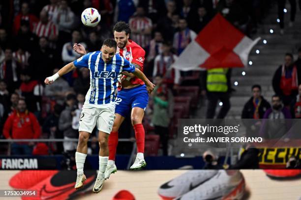 Alaves' Spanish defender Andoni Gorosabel and Atletico Madrid's Spanish defender Mario Hermoso vie for a header during the Spanish league football...