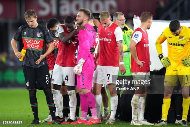 Players stand around Bas Dost of NEC Nijmegen after he collapsed during the Dutch Eredivisie match between AZ Alkmaar and NEC Nijmegen at the AFAS...