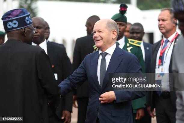 German Chancellor Olaf Scholz is welcomed by Nigeria's President Bola Ahmed Tinubu for a bilateral meeting in Abuja on October 29, 2023.