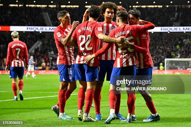 Atletico Madrid's Spanish midfielder Rodrigo Riquelme celebrates with teammates scoring the opening goal during the Spanish league football match...