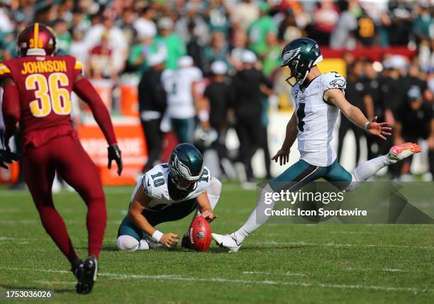 Philadelphia Eagles holder Braden Mann spots the ball for kicker Jake Elliott to kick a field goal as Washington Commanders defensive back Danny...