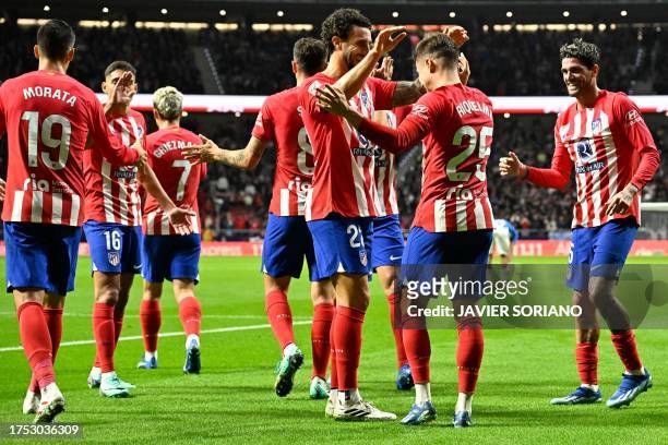 Atletico Madrid's Spanish midfielder Rodrigo Riquelme celebrates with teammates scoring the opening goal during the Spanish league football match...