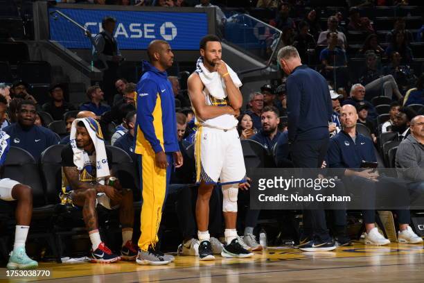 Chris Paul and Stephen Curry of the Golden State Warriors looks on during the game against the San Antonio Spurs on October 20, 2023 at Chase Center...