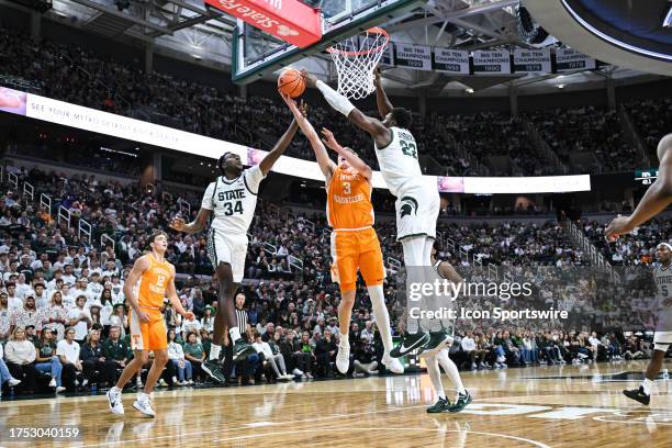Tennessee Volunteers guard Dalton Knecht gets his shot blocked by Michigan State Spartans center Mady Sissoko during a college basketball exhibition...