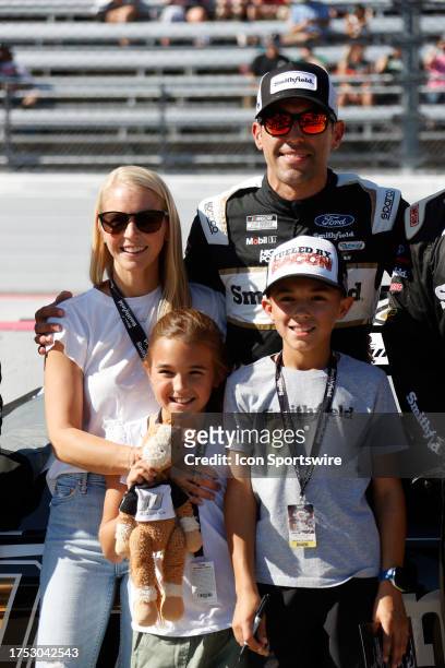 Aric Almirola poses for a picture with wife Janice, son Alex and daughter Abby on pit road prior to the running of the NASCAR Cup Series Playoff...