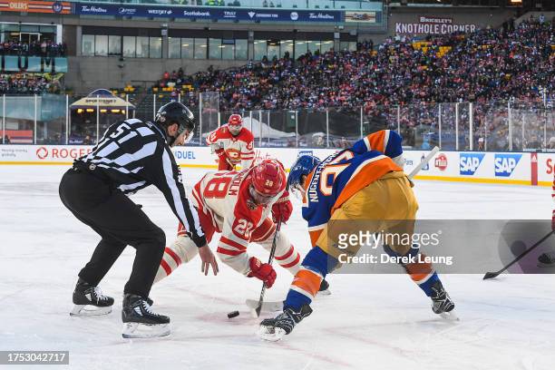 Elias Lindholm of the Calgary Flames faces off against Ryan Nugent-Hopkins of the Edmonton Oilers during the first period of the 2023 Tim Hortons NHL...