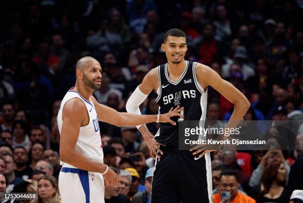 Victor Wembanyama of the San Antonio Spurs is defended by Nicolas Batum of the Los Angeles Clippers during the first half at Crypto.com Arena on...