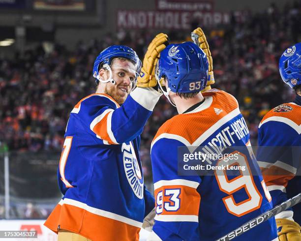 Connor McDavid and Ryan Nugent-Hopkins of the Edmonton Oilers celebrate after defeating the Calgary Flames during the third period of the 2023 Tim...