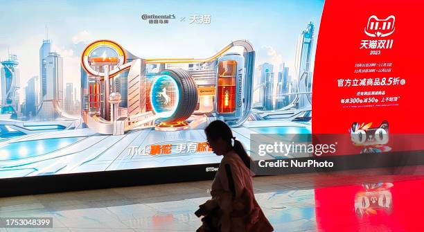 Citizens pass by the Double 11 shopping carnival promotional LCD screen displayed in a subway in Shanghai, China, October 27, 2023.