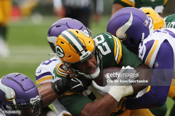 Green Bay Packers running back AJ Dillon runs with three Minnesota Vikings defenders in tow during a game between the Green Bay Packers and the...