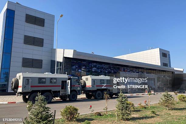 This photograph shows Russian National Guard vans parked at the airport in Makhachkala on October 30, 2023. Russian police on October 30, 2023 said...