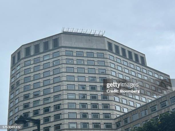 Scaffolding above a blank space where the sign has been removed from the facade of Credit Suisse's headquarters at One Cabot Square in Canary Wharf...