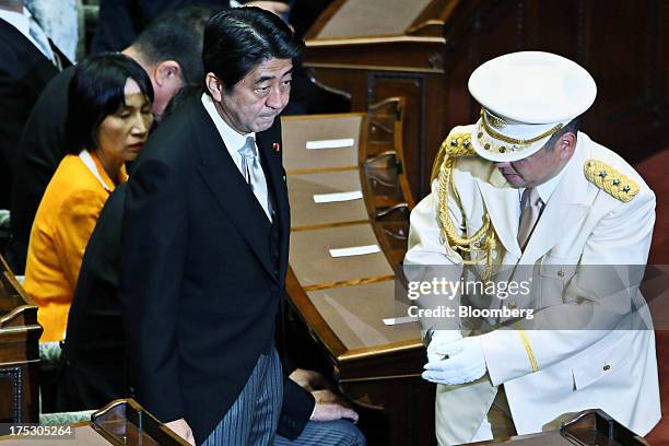 Shinzo Abe, Japan's prime minister, left, arrives for the opening session at the upper house of parliament in Tokyo, Japan, on Friday, Aug. 2, 2013....