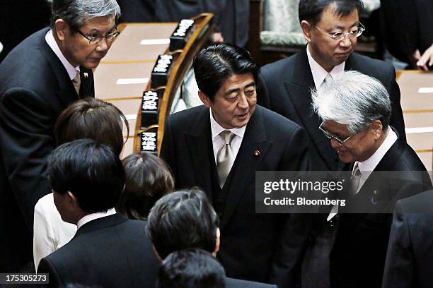 Shinzo Abe, Japan's prime minister, center, leaves the opening session at the upper house of parliament in Tokyo at the National Diet in Tokyo,...