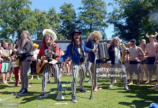 Band plays at the public open-air swimming pool at the Wacken Open Air heavy metal music fest on August 2, 2013 in Wacken, Germany. Approximately...