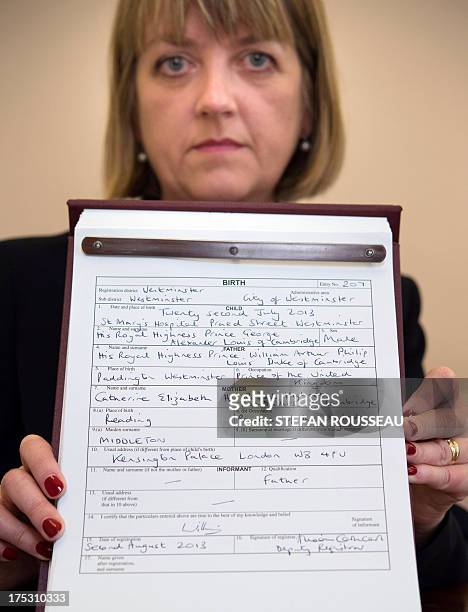 Westminster City Council registrar Alison Cathcart holds a copy of the birth certificate for Prince George of Cambridge, after the birth registration...