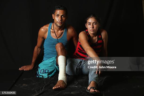 Undocumented immigrants Eduardo Contreras from Honduras and Elvira Lopez from Guatemala sit at the Jesus el Buen Pastor shelter on July 31, 2013 in...