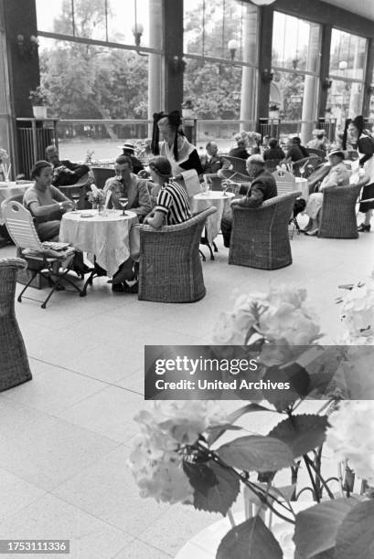 Visitors of the restaurant in the Kurhaus Casino in Baden-Baden are being served by waitresses wearing a traditional Black Forrest costume with the...