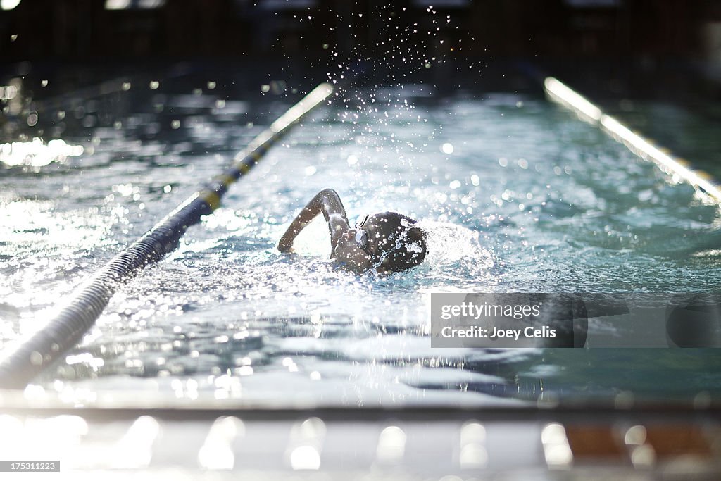 Child swimming laps in a pool