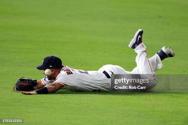 Michael Brantley of the Houston Astros misses a catch hit by Mitch Garver of the Texas Rangers to score Adolis Garcia during the first inning in Game...