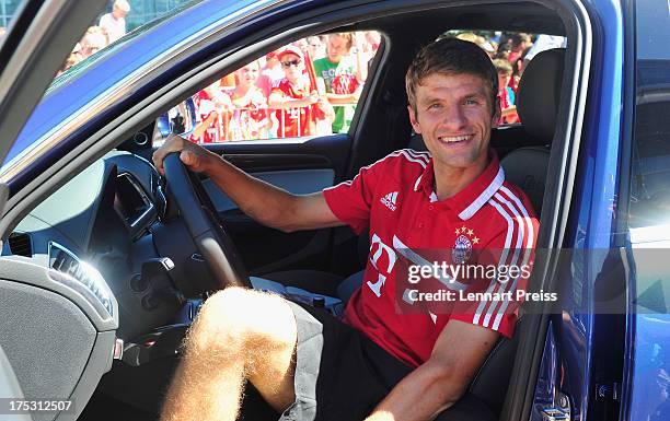 Thomas Mueller of FC Bayern Muenchen poses in a car during the handover of the new cars at Audi Forum on August 2, 2013 in Ingolstadt, Germany.