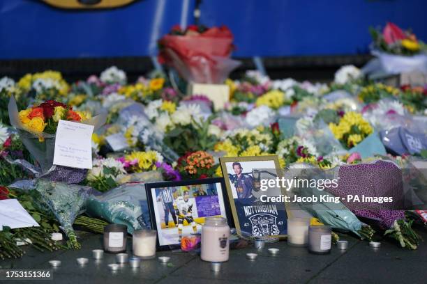 Lit candles among the flowers and messages left in tribute to Nottingham Panthers' ice hockey player Adam Johnson outside the Motorpoint Arena in...