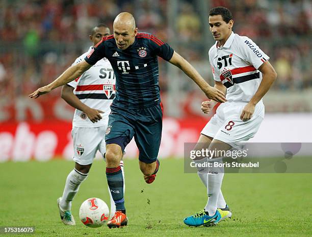 Arjen Robben of Muenchen is chased by Pablo Henrique Ganso of Sao Paulo during the Audi Cup 2013 semifinal match between FC Bayern Muenchen and FC...