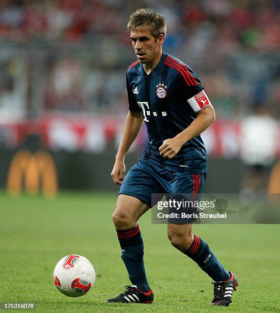 Philipp Lahm of Muenchen runs with the ball during the Audi Cup 2013 semifinal match between FC Bayern Muenchen and FC Sao Paulo at Allianz Arena on...