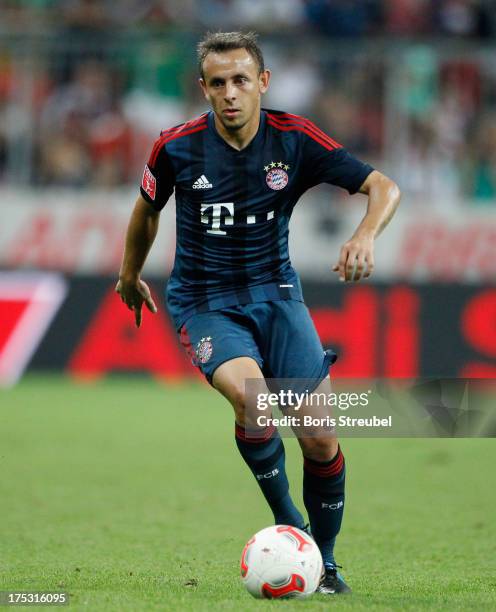 Rafinha of Muenchen runs with the ball during the Audi Cup 2013 semifinal match between FC Bayern Muenchen and FC Sao Paulo at Allianz Arena on July...