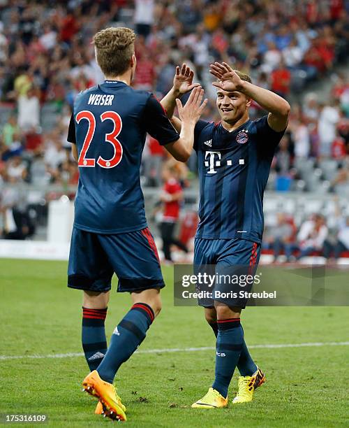 Mitchell Weiser of Muenchen celebrates scoring his team's second goal with Xherdan Shaqiri during the Audi Cup 2013 semifinal match between FC Bayern...