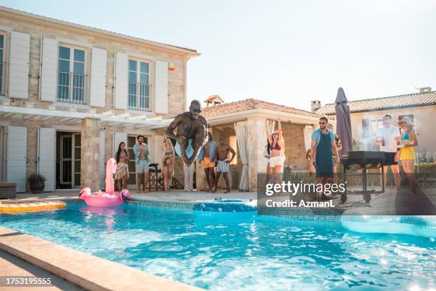 joyful black male's cannonball splash - cannonball pool stock pictures, royalty-free photos & images