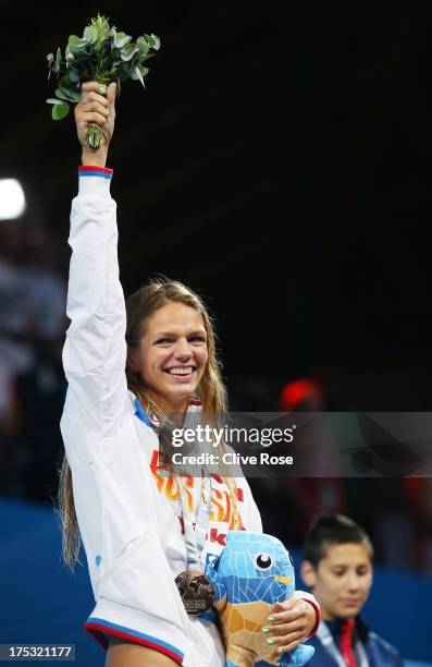 Gold medal winner Yuliya Efimova of Russia celebrates on the podium after the Swimming Women's Breaststroke 200m Final on day fourteen of the 15th...