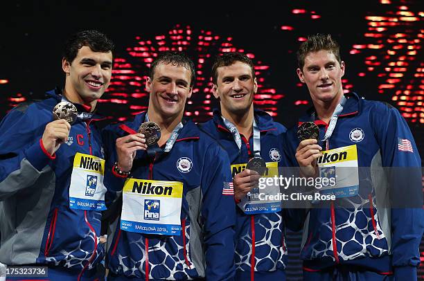 Gold medal winners Conor Dwyer, Ryan Lochte, Charlie Houchin and Ricky Berens of the USA celebrate on the podium after the Men's Freestyle 4x200m...