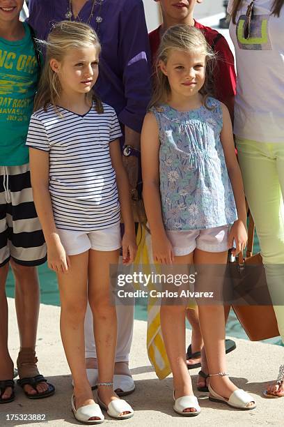 Princess Leonor of Spain and her sister Princess Sofia of Spain pose for the photographers at the Calanova Sailing School on August 02, 2013 in Palma...