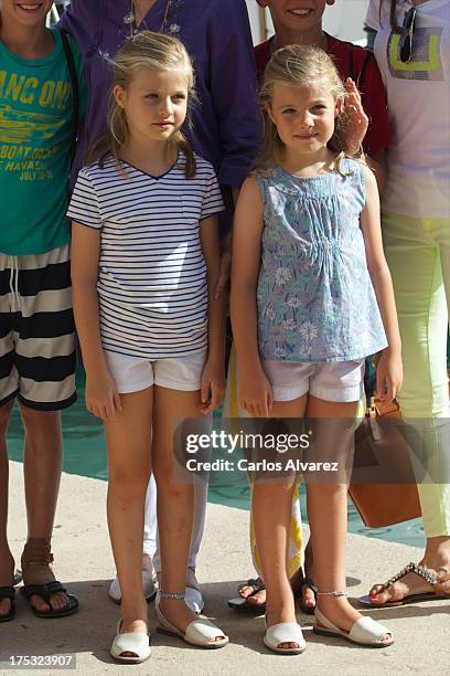 Princess Leonor of Spain and her sister Princess Sofia of Spain pose for the photographers at the Calanova Sailing School on August 02, 2013 in Palma...